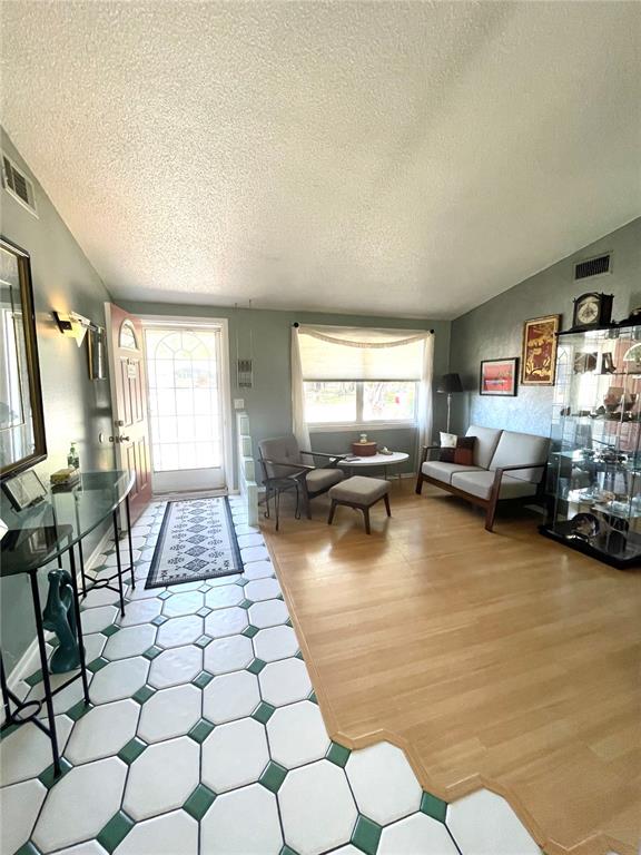 6944 Larchmont Avenue New Port Richey, FL 34653 - Photo 3 of 28 a living room with furniture and a flat screen tv