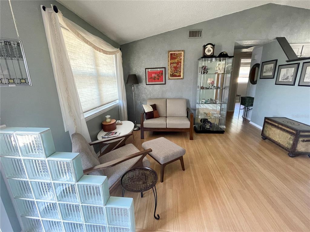 6944 Larchmont Avenue New Port Richey, FL 34653 - Photo 4 of 28 a living room with furniture and wooden floor