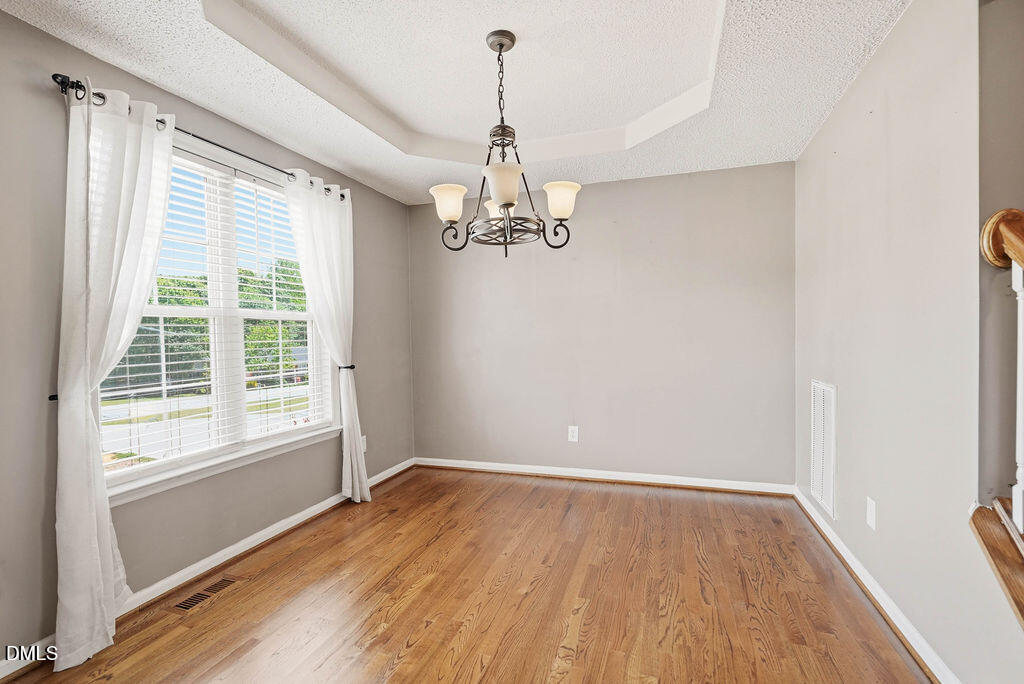 1560 Cane Mill Road Coats, NC 27521 - Photo 7 of 32 a view of a room with wooden floor chandelier and windows