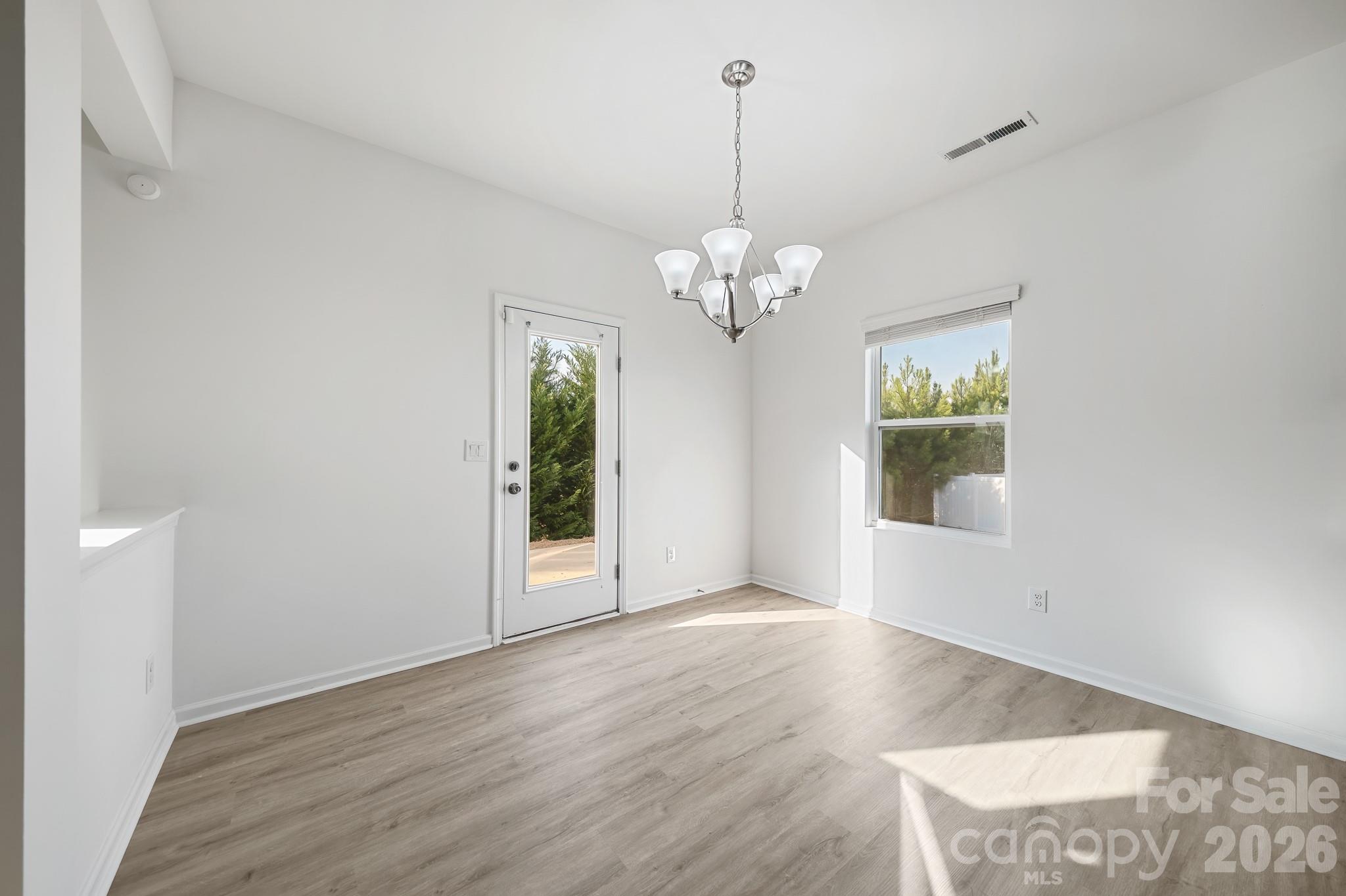 2838 Kinloch Court Clover, SC 29710 - Photo 20 of 42 a view of livingroom with chandelier fan and wooden floor