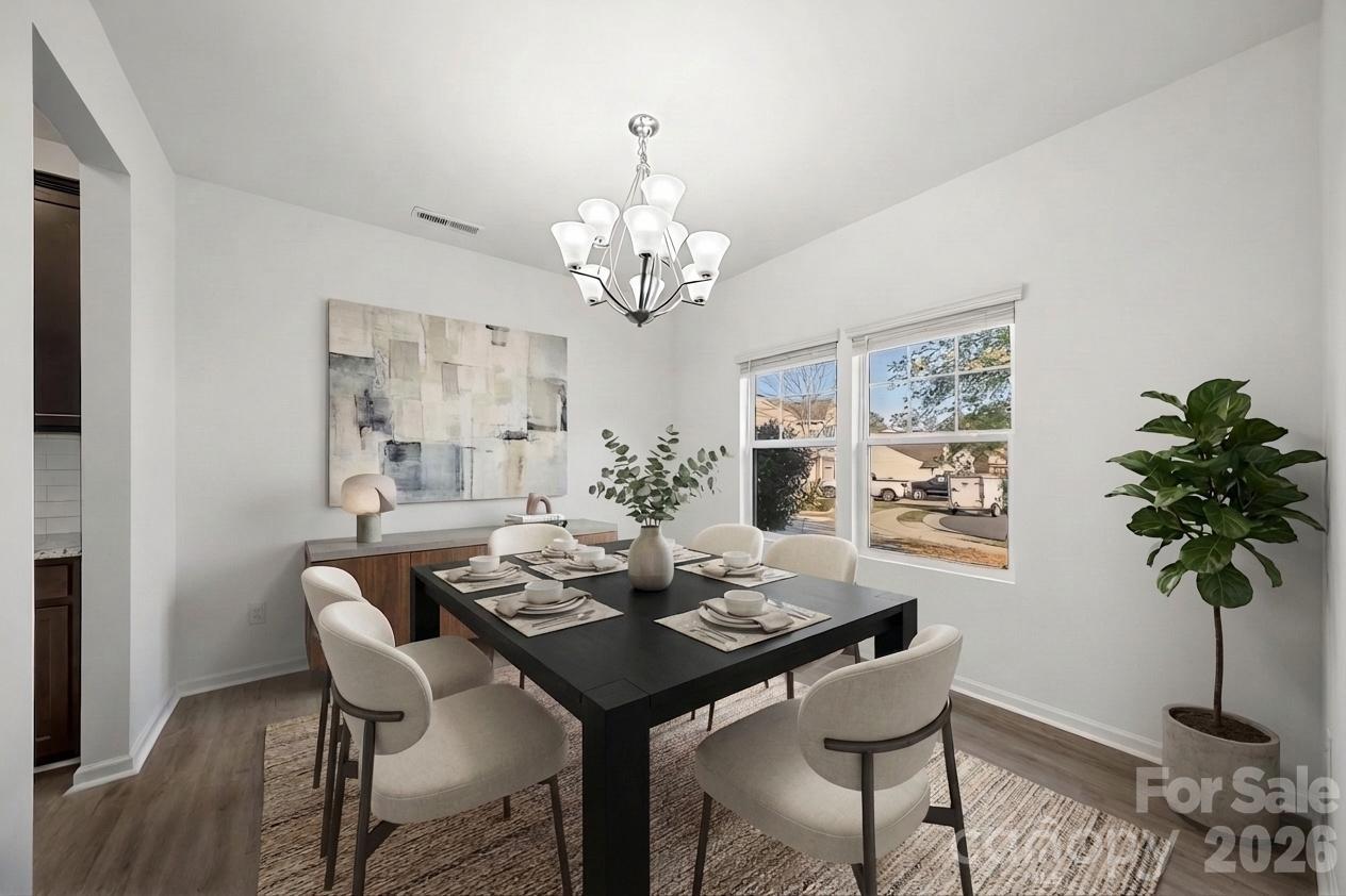 2838 Kinloch Court Clover, SC 29710 - Photo 4 of 42 a view of a dining room with furniture a chandelier and wooden floor