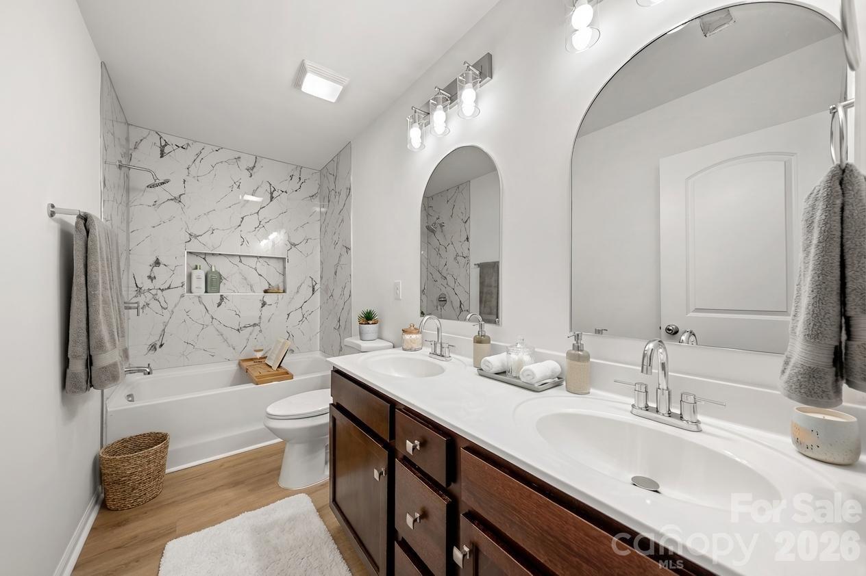 2838 Kinloch Court Clover, SC 29710 - Photo 10 of 42 a spacious bathroom with double vanity sinks a large mirror and a bathtub