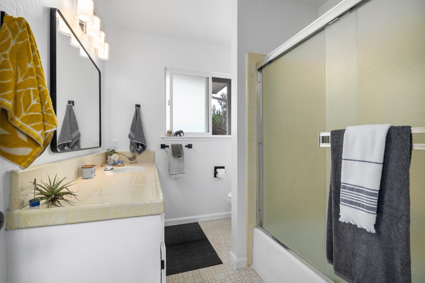326 Doris Avenue Aptos, CA 95003 - Photo 29 of 48 a bathroom with a sink and mirror with bathtub