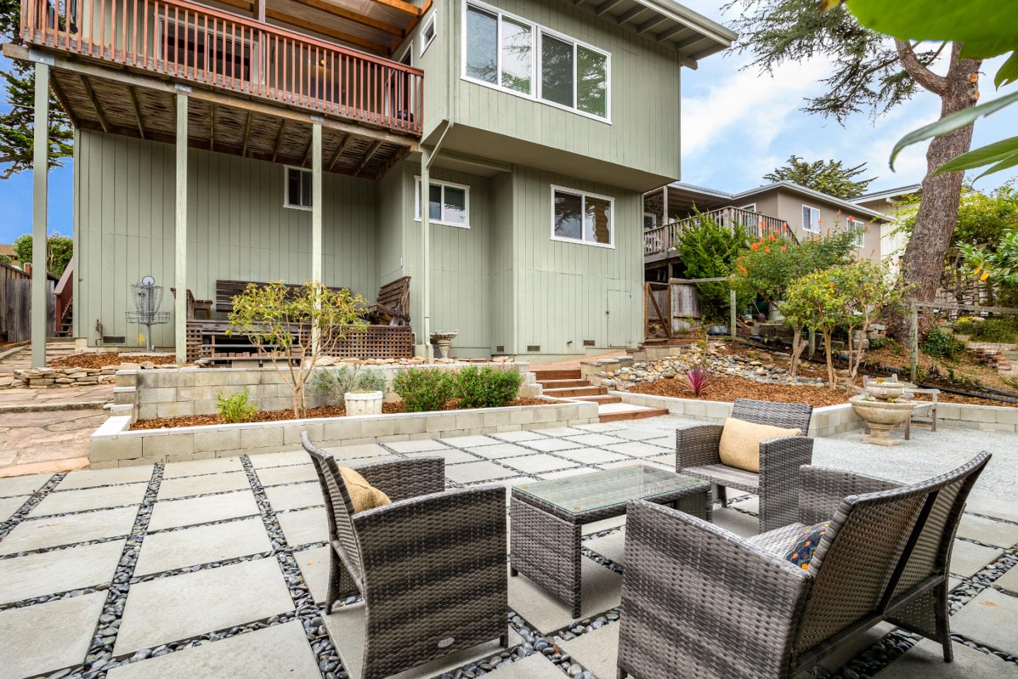 326 Doris Avenue Aptos, CA 95003 - Photo 35 of 48 a view of a patio with couches table and chairs and potted plants