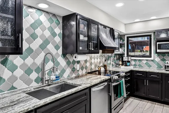a kitchen with a sink stove and cabinets