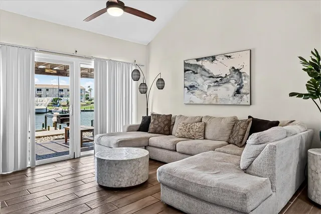a living room with furniture and a painting on the wall