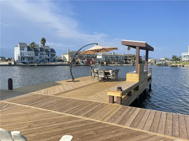 a swimming pool view with a seating space