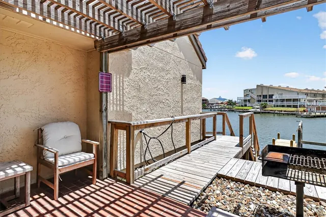a view of balcony with wooden floor and seating space