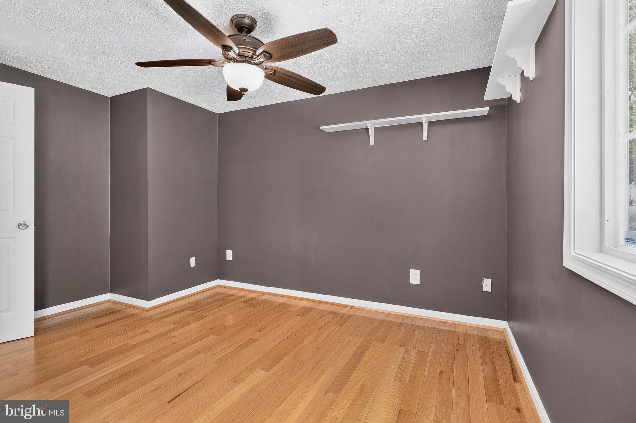 8471 Great Lake Lane Springfield, VA 22153 - Photo 20 of 65 a view of a big room with wooden floor and windows