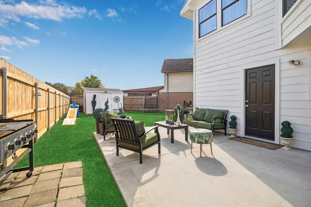 a view of a patio with a table and chairs