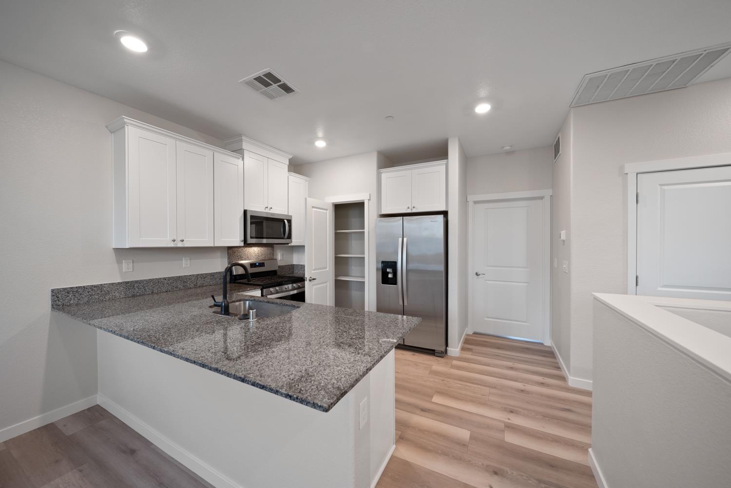 3286 New York Road West Sacramento, CA 95691 - Photo 7 of 22 a kitchen with stainless steel appliances granite countertop a sink a stove and a refrigerator