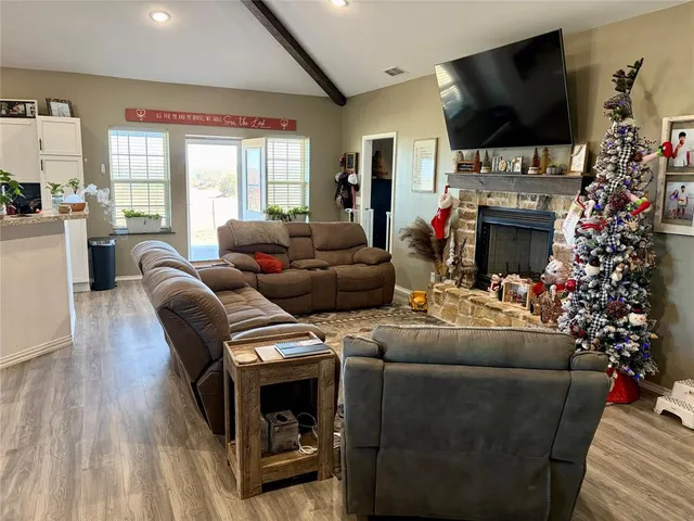 a living room with fireplace furniture and a flat screen tv