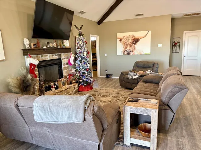 a room with kitchen island a sink and a stove with wooden floor
