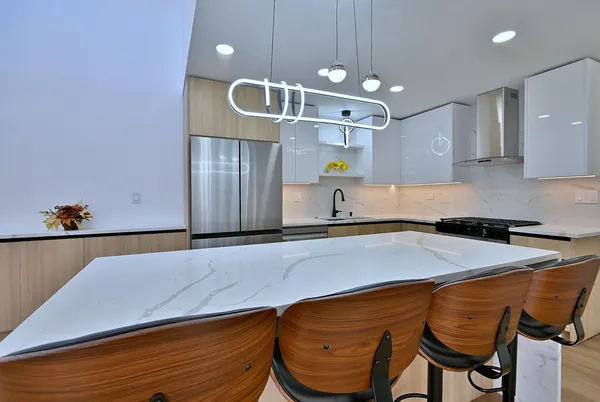 a kitchen with a sink cabinets and wooden floor