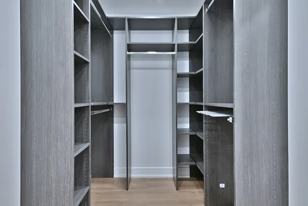 a view of walk in closet with empty racks