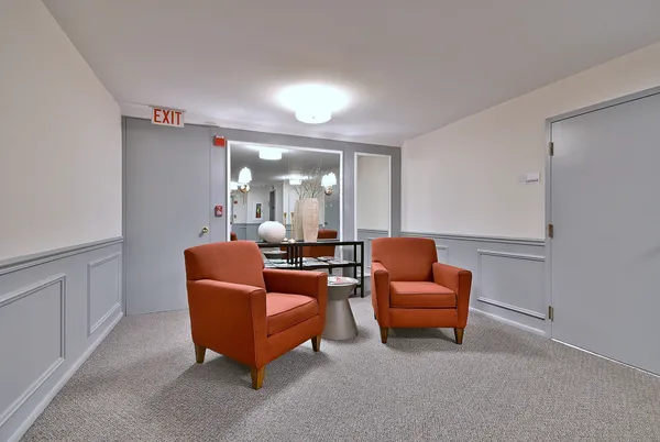 a living room with furniture and a mirror