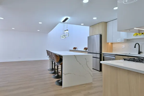 a kitchen with stainless steel appliances a refrigerator sink and stove