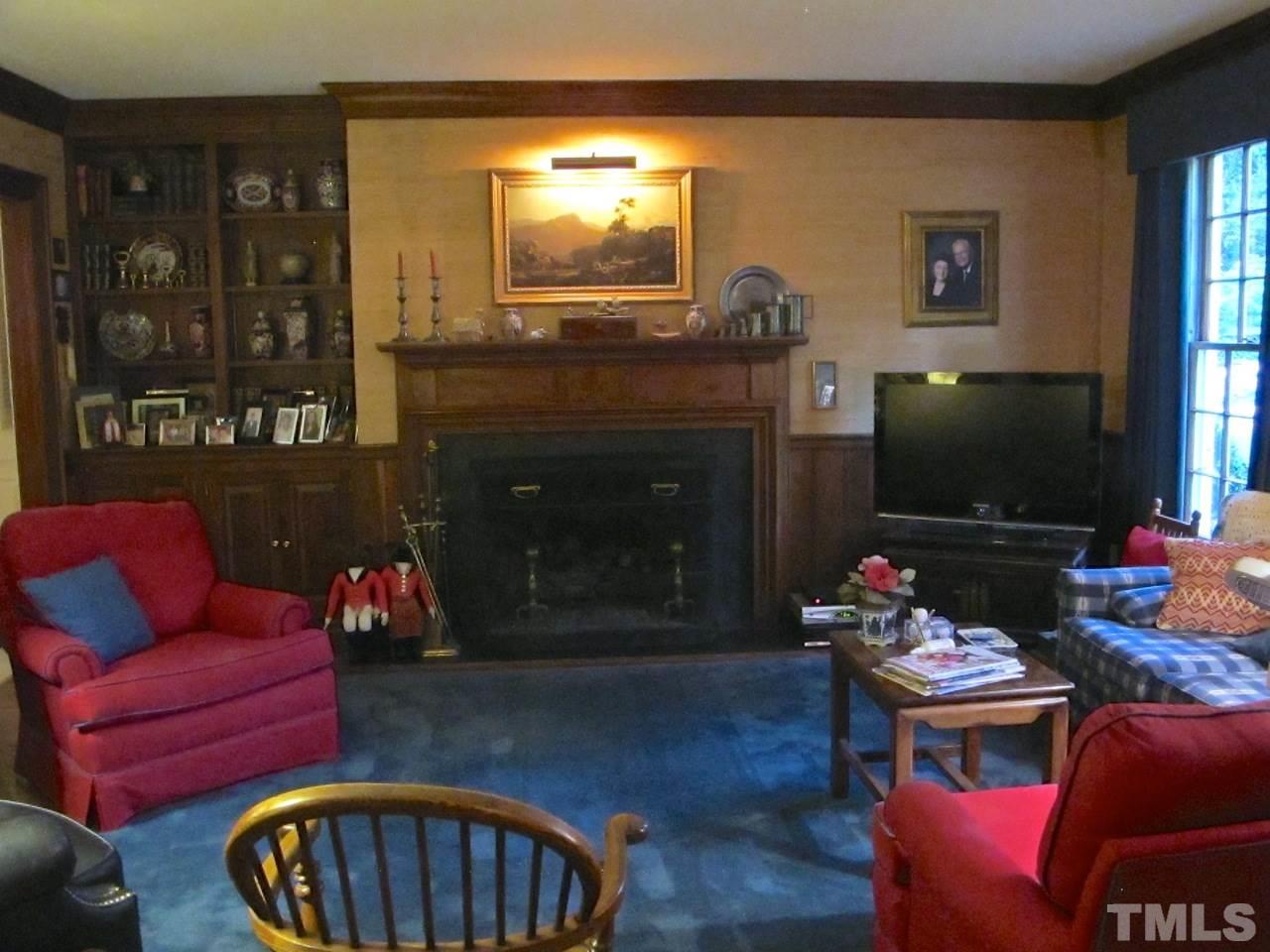 3321 Landor Road Raleigh, NC 27609 - Photo 14 of 25 a living room with furniture a flat screen tv and floor to ceiling window