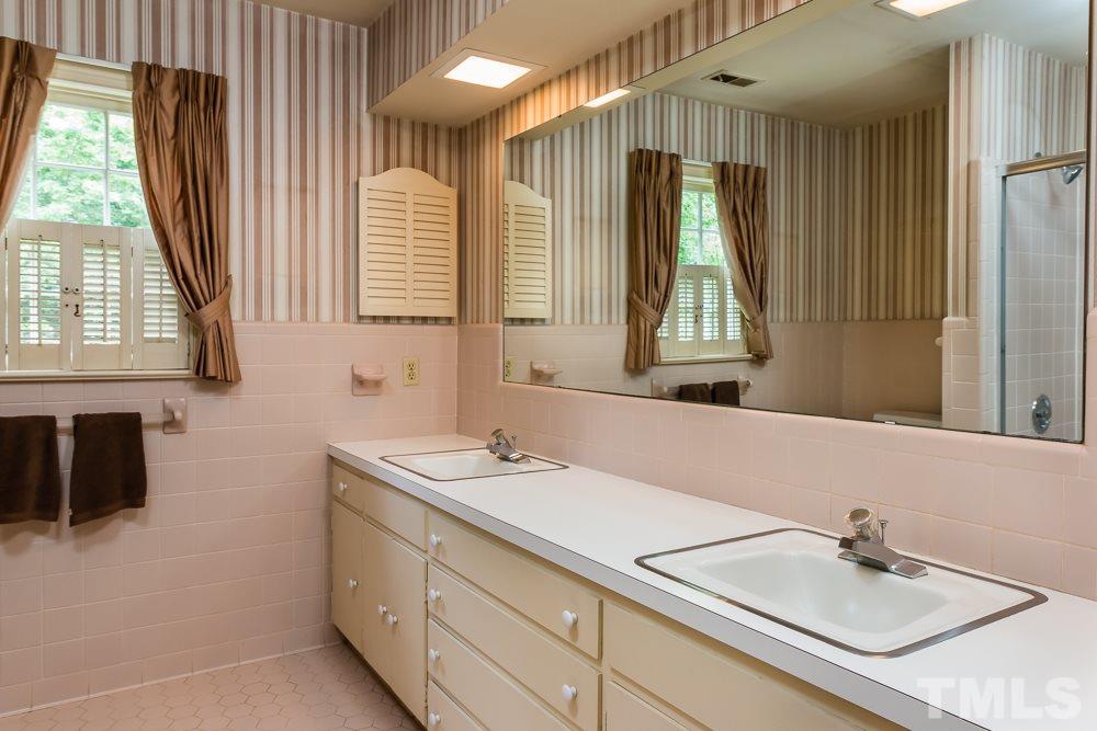 3321 Landor Road Raleigh, NC 27609 - Photo 22 of 25 a bathroom with a sink and a mirror