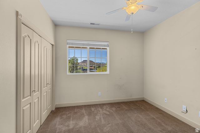 389 North Main Street St. George, UT 84770 - Photo 13 of 44 Unfurnished bedroom with carpet floors, a closet, and a ceiling fan