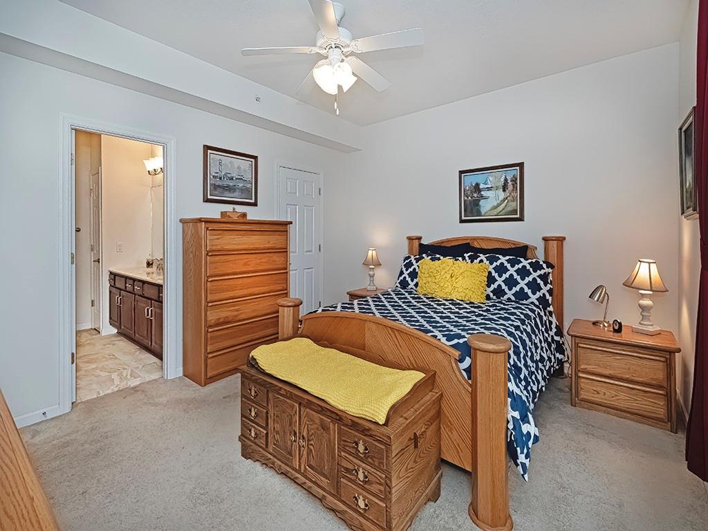 115 Shelton Place Drive Evans City, PA 16033 - Photo 16 of 24 a bedroom with a bed and a chandelier