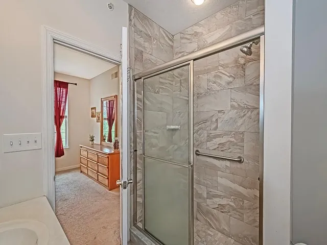 a bathroom with a shower and a sink