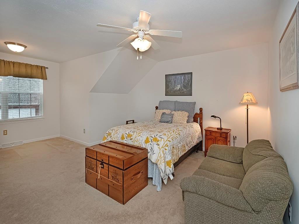 115 Shelton Place Drive Evans City, PA 16033 - Photo 19 of 24 a spacious bedroom with a bed and a chandelier