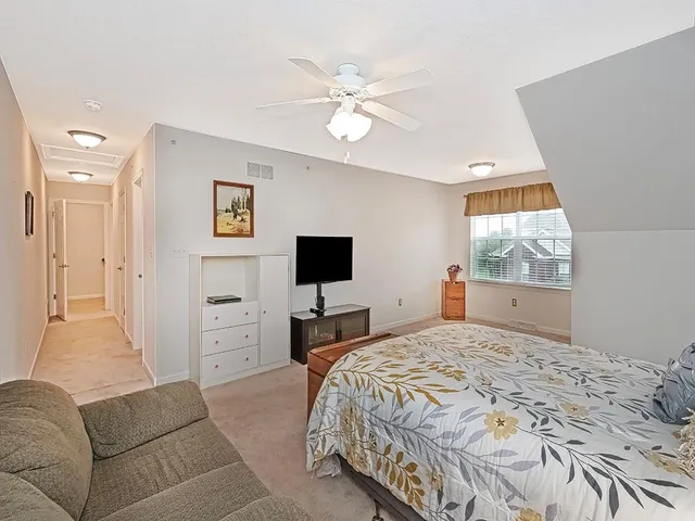 a bedroom with a large bed and a window