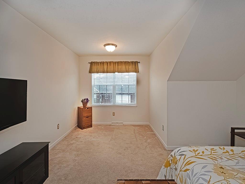 115 Shelton Place Drive Evans City, PA 16033 - Photo 21 of 24 a bedroom with a bed and a flat screen tv