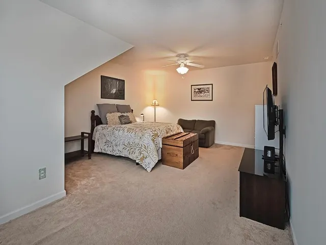a living room with furniture and a ceiling fan