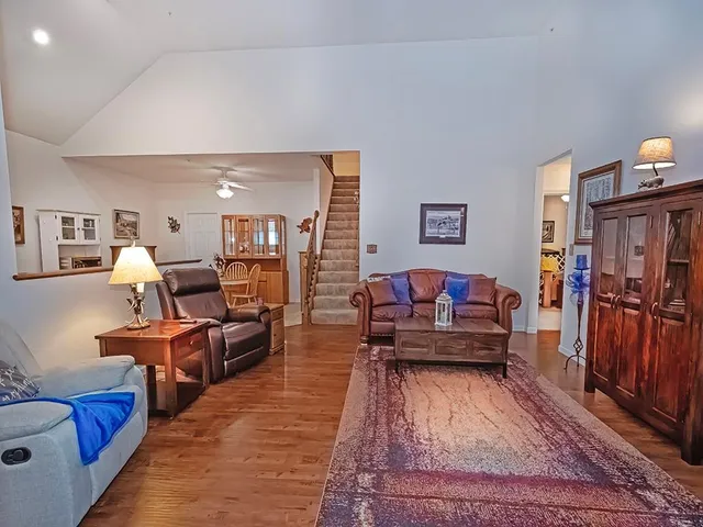 a living room with furniture rug and wooden floor