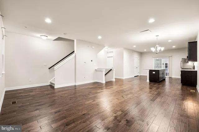 a view of kitchen with stove and wooden floor