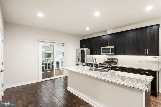 a kitchen with sink cabinets and microwave
