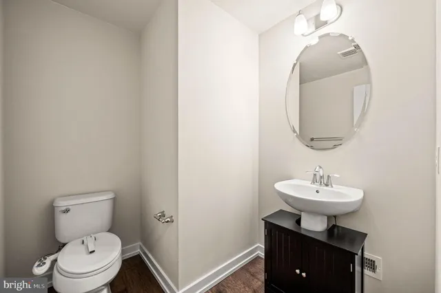 a bathroom with a sink a mirror and a toilet