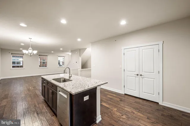 a kitchen with a counter top space and wooden floor