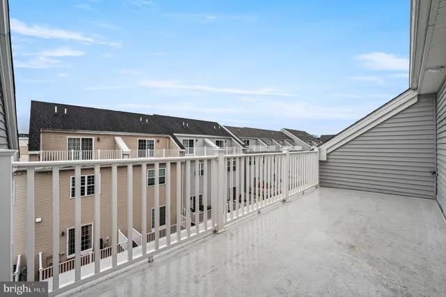 a view of a house with wooden fence