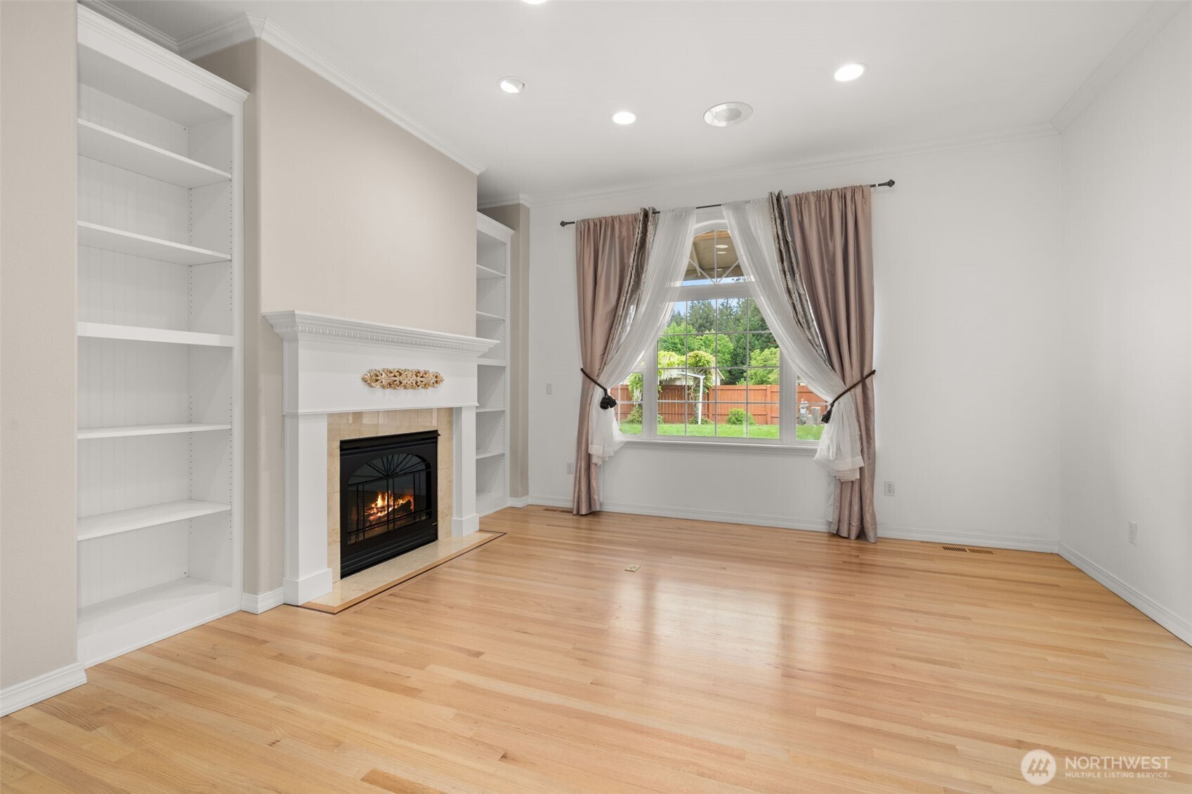 9609 346th Street South Roy, WA 98580 - Photo 6 of 37 a view of empty room with a fireplace and wooden floor