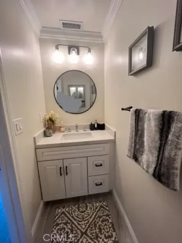 a bathroom with a sink mirror and vanity