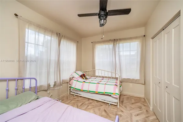 a bedroom with a bed and a window