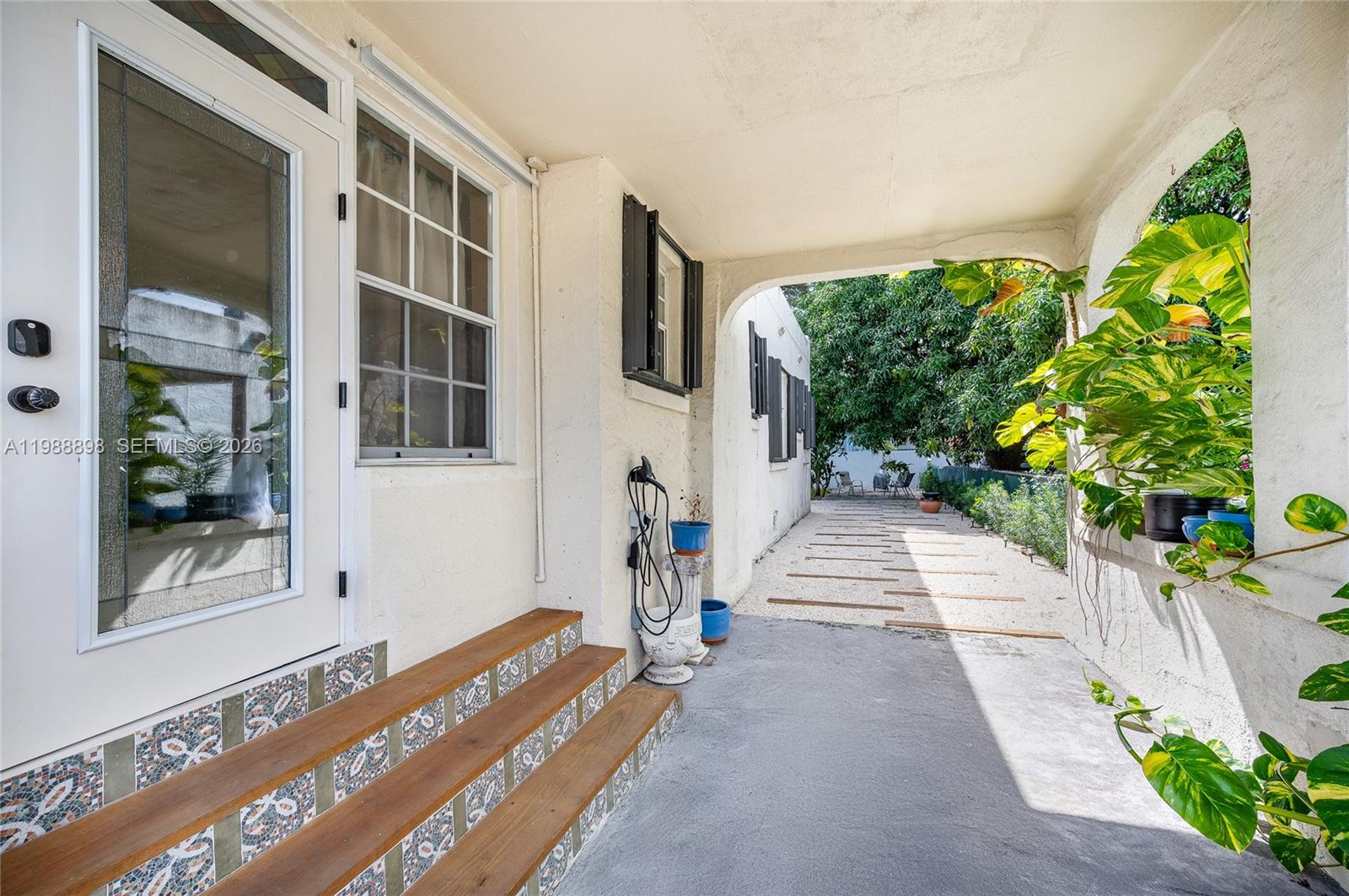 1844 Northwest 47th Street Miami, FL 33142 - Photo 4 of 24 a front view of a house with a yard and potted plants