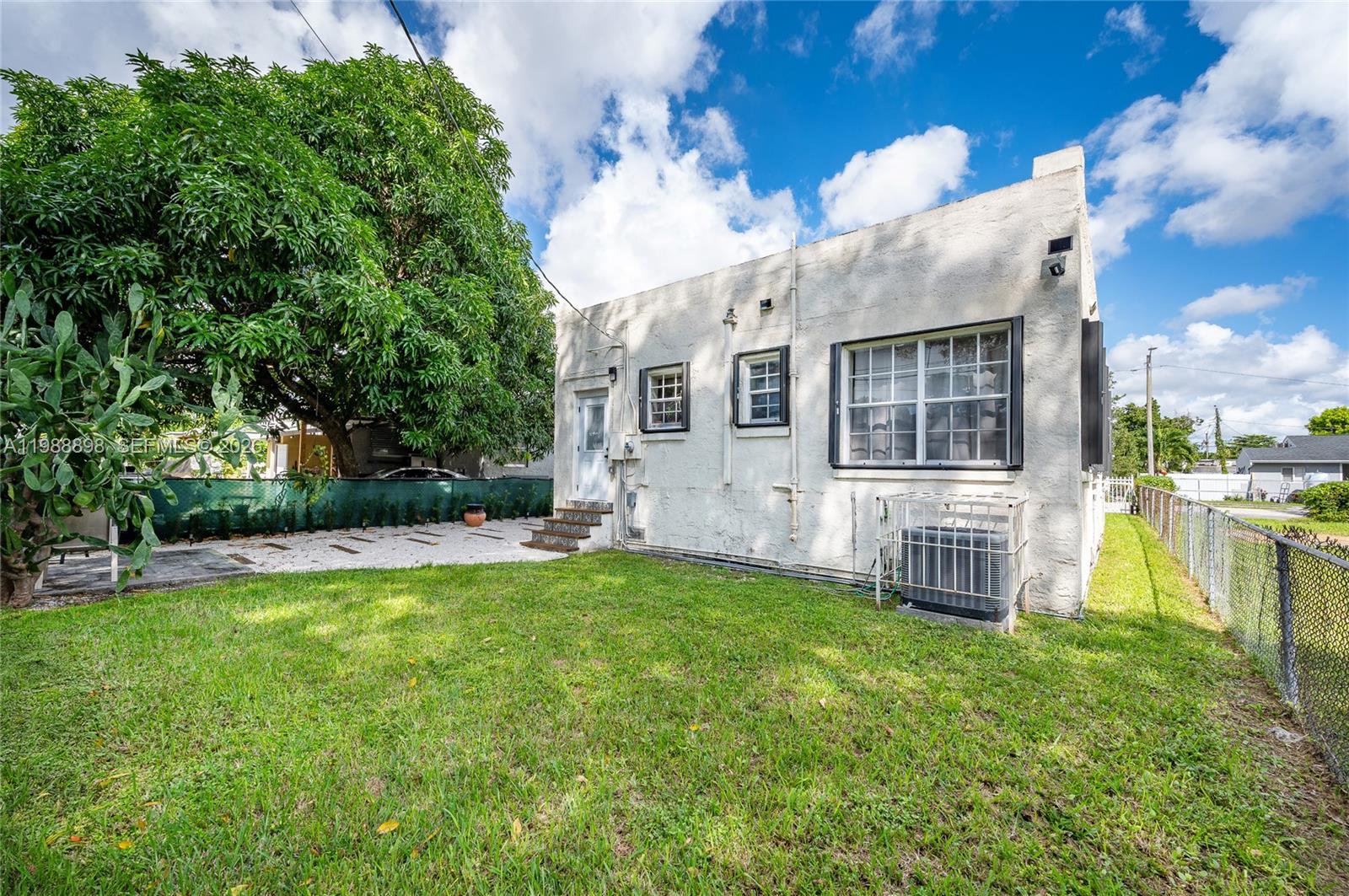 1844 Northwest 47th Street Miami, FL 33142 - Photo 9 of 24 a view of a house with a yard and sitting area