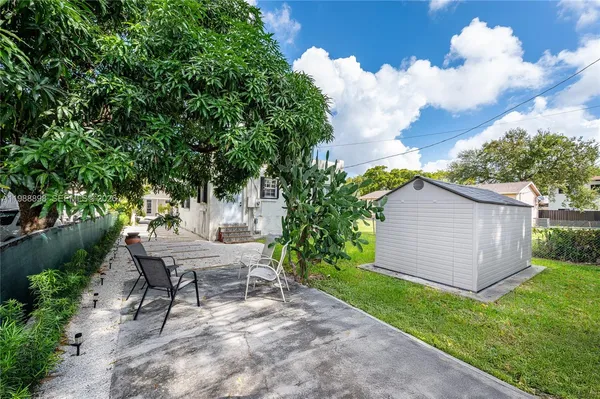 a view of a house with a yard and sitting area