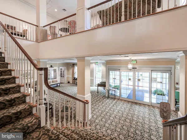 a view of a livingroom with furniture wooden floor and windows