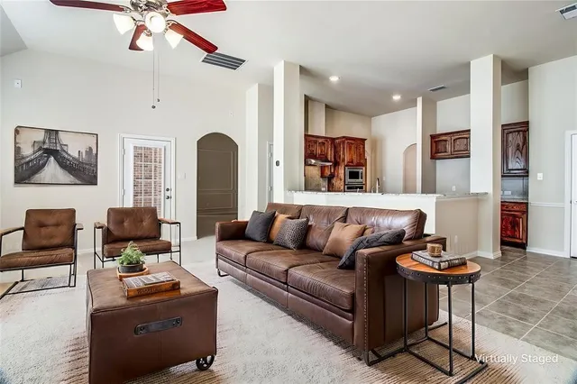a living room with furniture and a large window