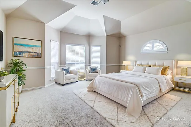 a bedroom with a bed and a couch