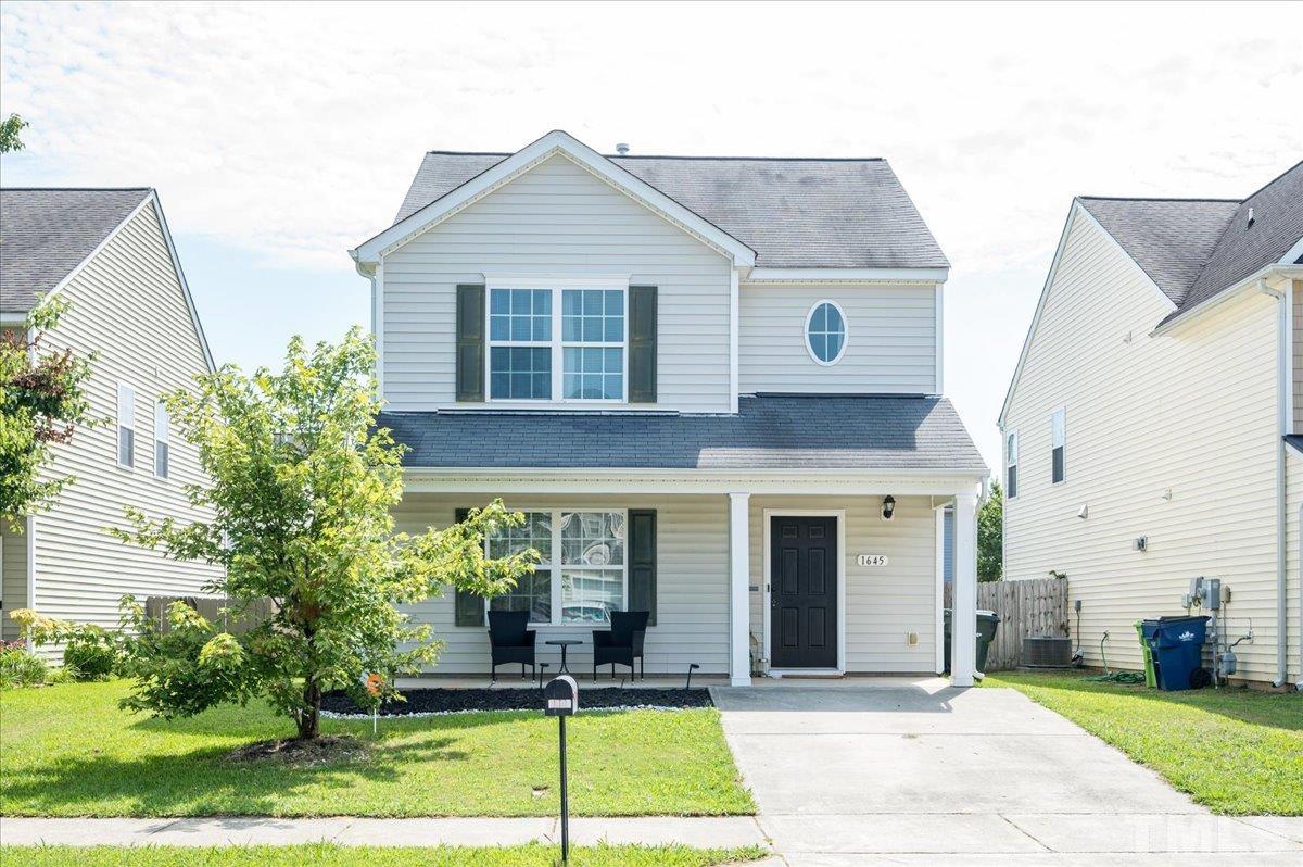 1645 Extine Lane Raleigh, NC 27610 - Photo 1 of 18 a front view of a house with garden