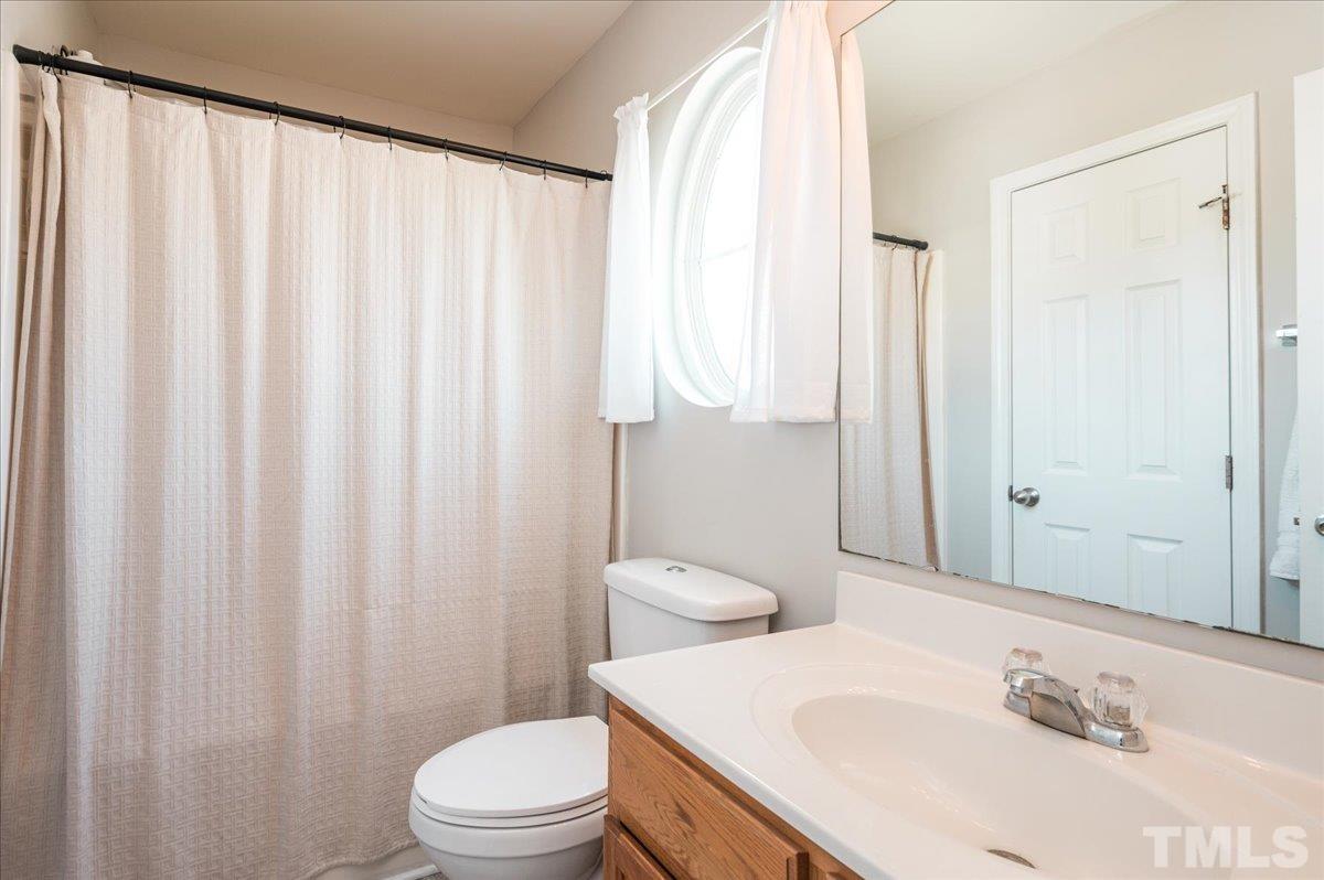 1645 Extine Lane Raleigh, NC 27610 - Photo 11 of 18 a bathroom with a sink toilet and shower