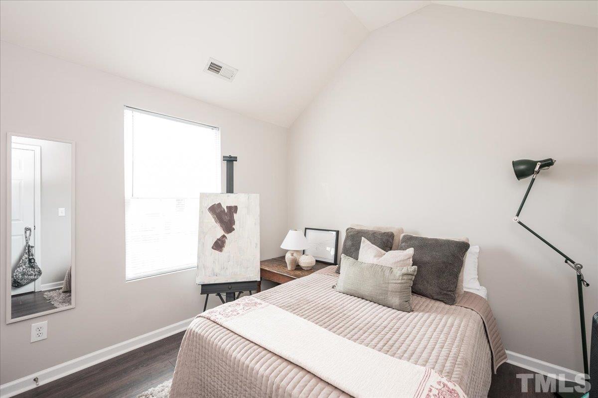 1645 Extine Lane Raleigh, NC 27610 - Photo 12 of 18 a bedroom with a bed and a window