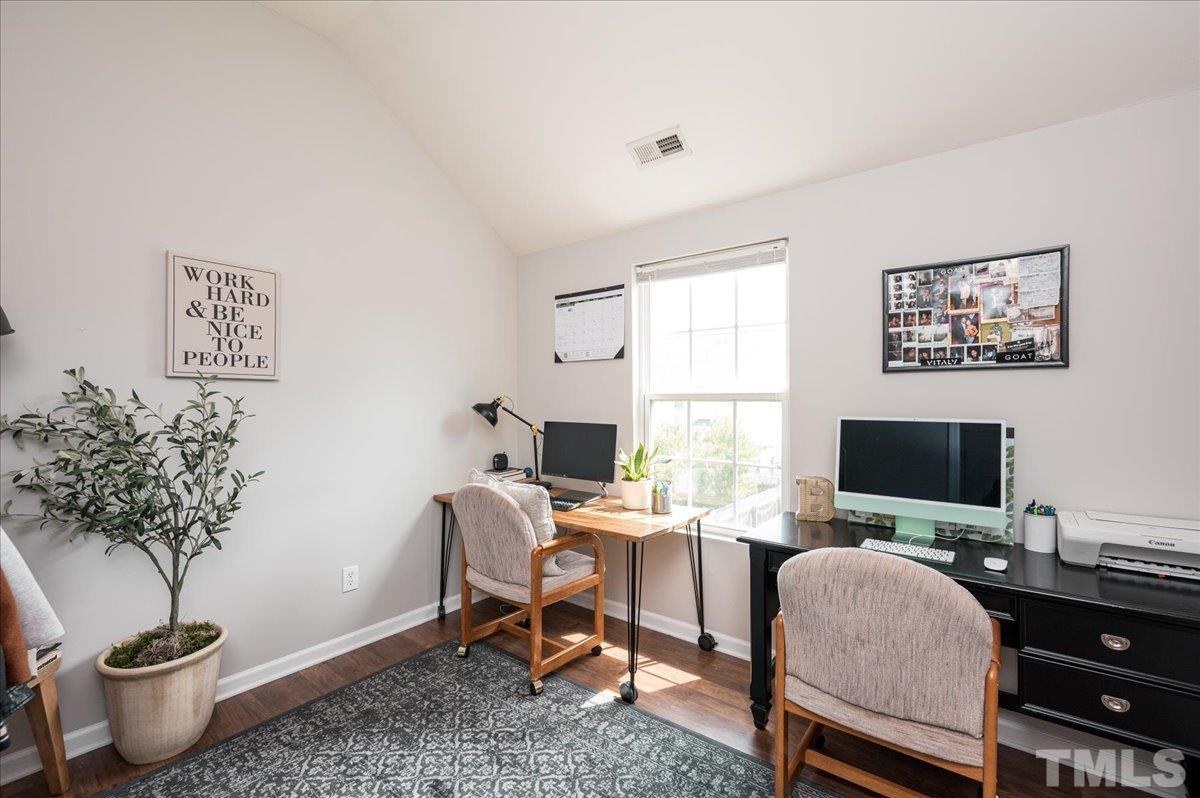 1645 Extine Lane Raleigh, NC 27610 - Photo 13 of 18 a living room with furniture potted plant and a flat screen tv