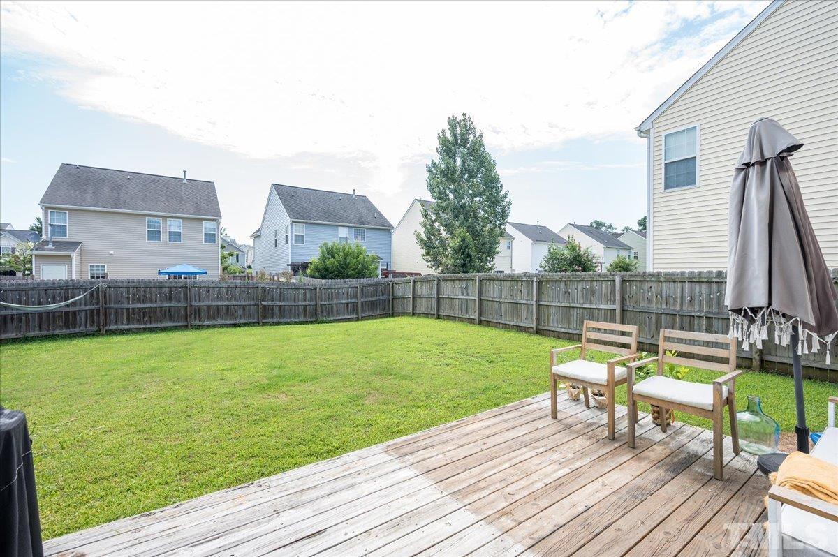 1645 Extine Lane Raleigh, NC 27610 - Photo 15 of 18 a view of a house with a backyard and a patio